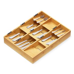 Fixed nine-compartment bamboo silverware drawer organizer filled with forks, spoons and knives on a white background