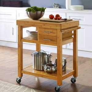 Bamboo rolling kitchen island cart with two drawers, open shelves and caster wheels in a kitchen