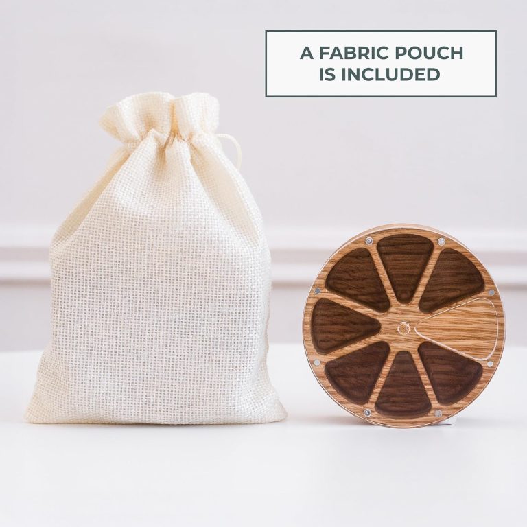 Empty round weekly pill organizer beside a fabric drawstring pouch with an included-pouch label