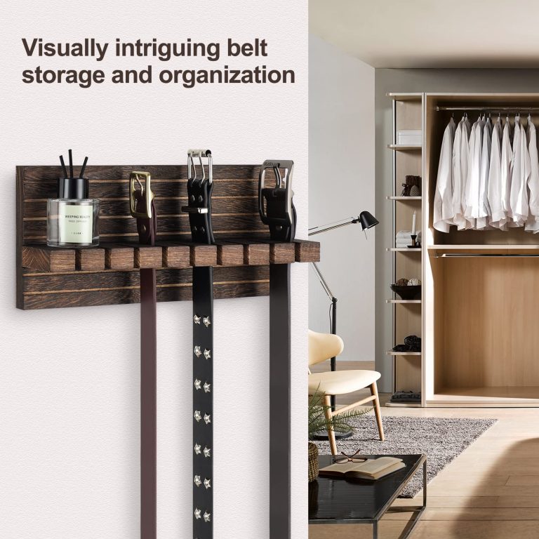Wood belt organizer mounted beside a wardrobe with three belts hanging from its slotted rail