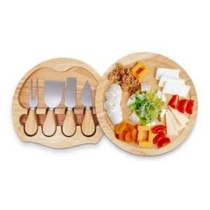 Round cheese board with a recessed four-tool tray open beside a platter of cheese and fruit