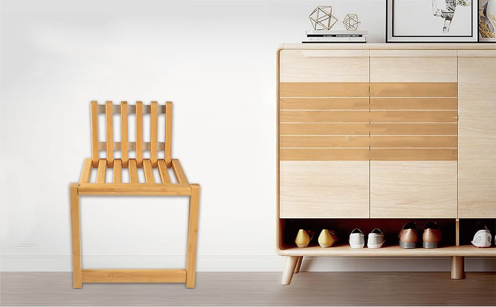 Front view of a wood-toned slatted folding chair beside a shoe cabinet in an entryway