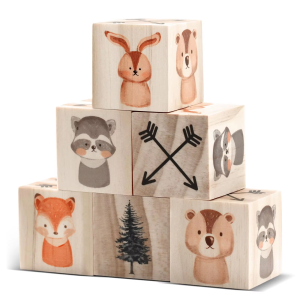 Wooden shelf decor blocks arranged in a six-block pyramid, showing rabbit, raccoon, fox, bear, tree and crossed-arrow prints