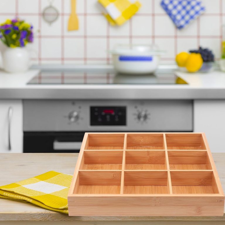 Empty nine-section bamboo tray on a kitchen counter beside a yellow checked cloth