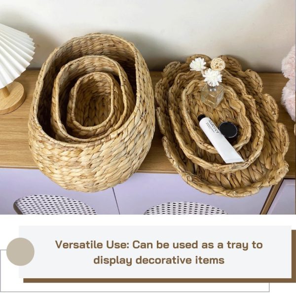 Three oval water hyacinth baskets nested together beside scalloped lids used as decorative trays