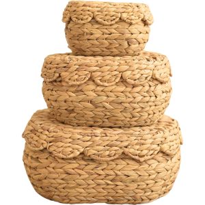 Water hyacinth storage basket set of three oval baskets stacked with scalloped lids on a white background