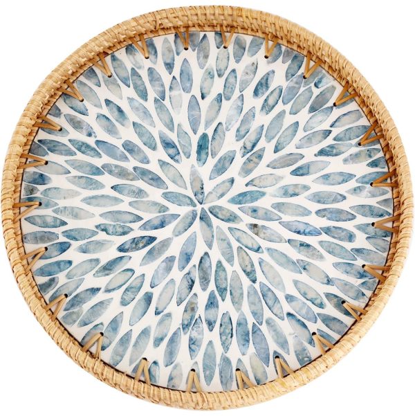 Round rattan tray with light blue mother of pearl leaf inlay and a natural woven rim on a white background