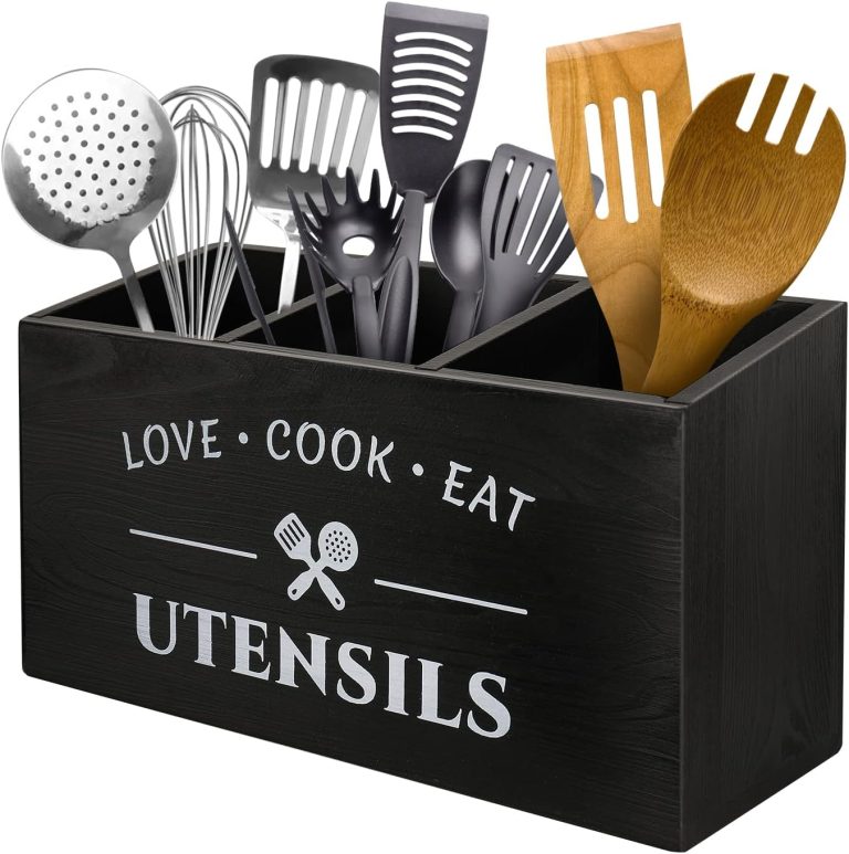 Black utensil storage holder with three compartments, white kitchen lettering and assorted cooking tools