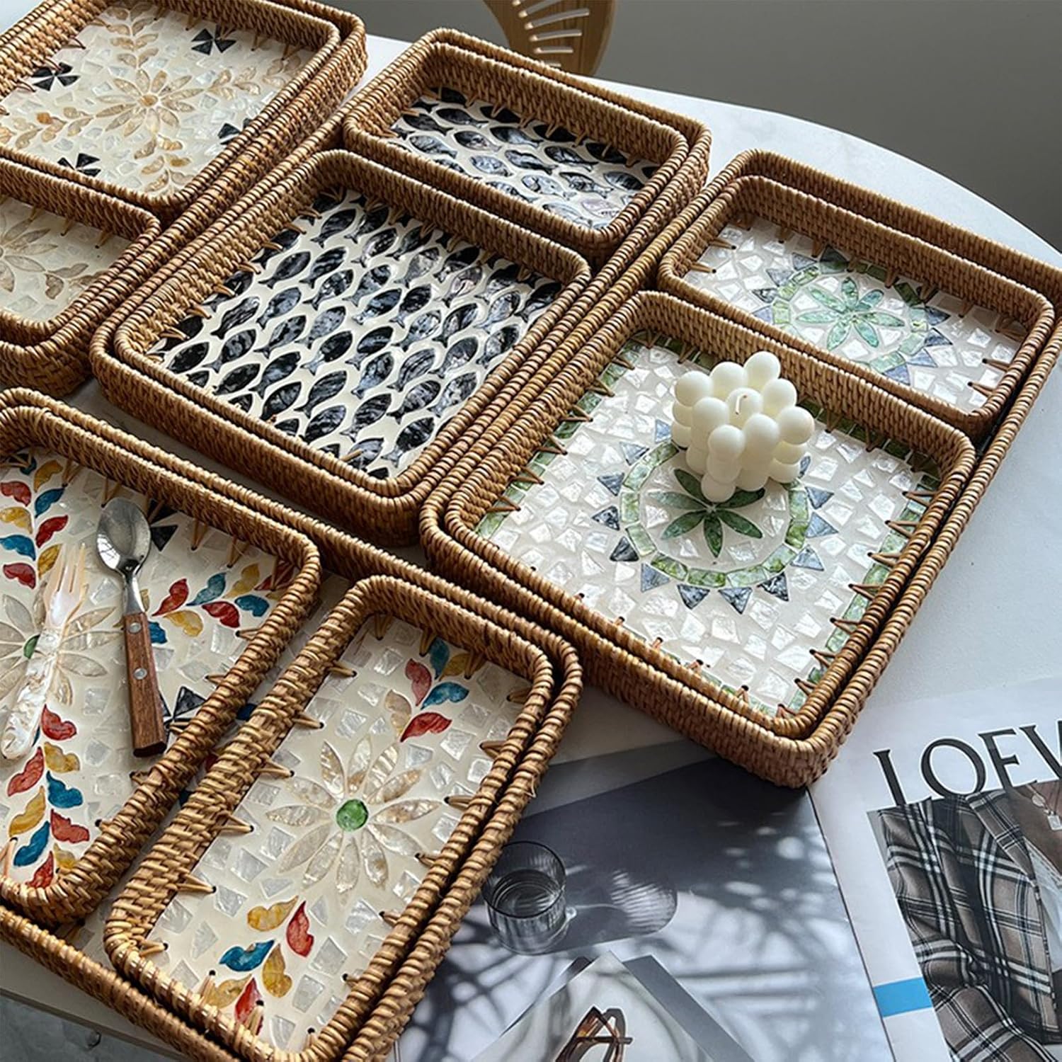 Close view of rattan shell trays with blue leaf, green geometric and colourful floral inlay patterns