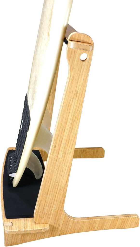 Side profile of a wood-grain paddleboard rack with a long rear foot and black base pad, pictured with a white board and fin