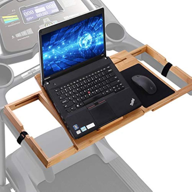 Bamboo laptop desk spanning treadmill handrails with two black securing straps, a laptop and a mouse
