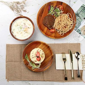 Acacia wood dinner plate, appetizer plate and bowl arranged with food on a dining table