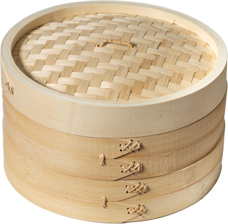 Two-tier bamboo steamer baskets stacked under a woven bamboo lid with a loop handle