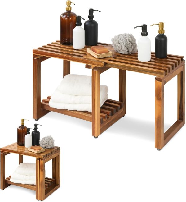 Extendable acacia wood bench holding toiletry bottles on top and folded towels on its lower shelf