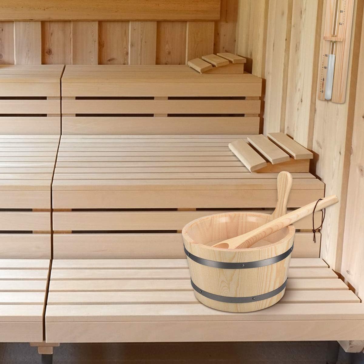 Pine sauna bucket with a wooden ladle on a sauna bench and a sand timer mounted on the wall