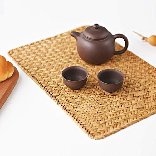 Rectangular seagrass woven placemat holding a small teapot and two cups