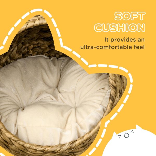 Close-up of a light-coloured padded cushion fitted inside the round woven cat basket