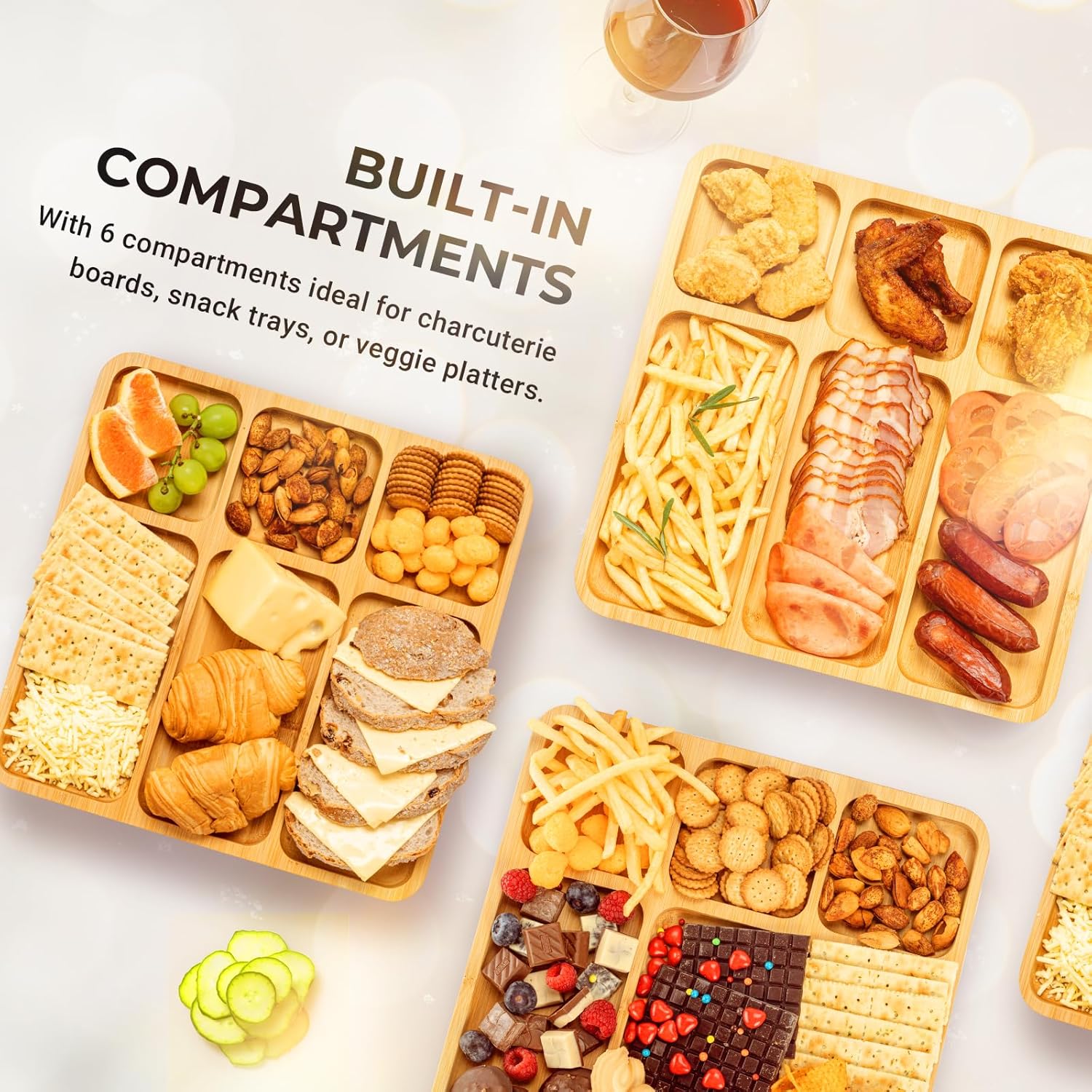 Six-compartment bamboo serving boards arranged with fruit, cheese, crackers, nuts and savoury snacks