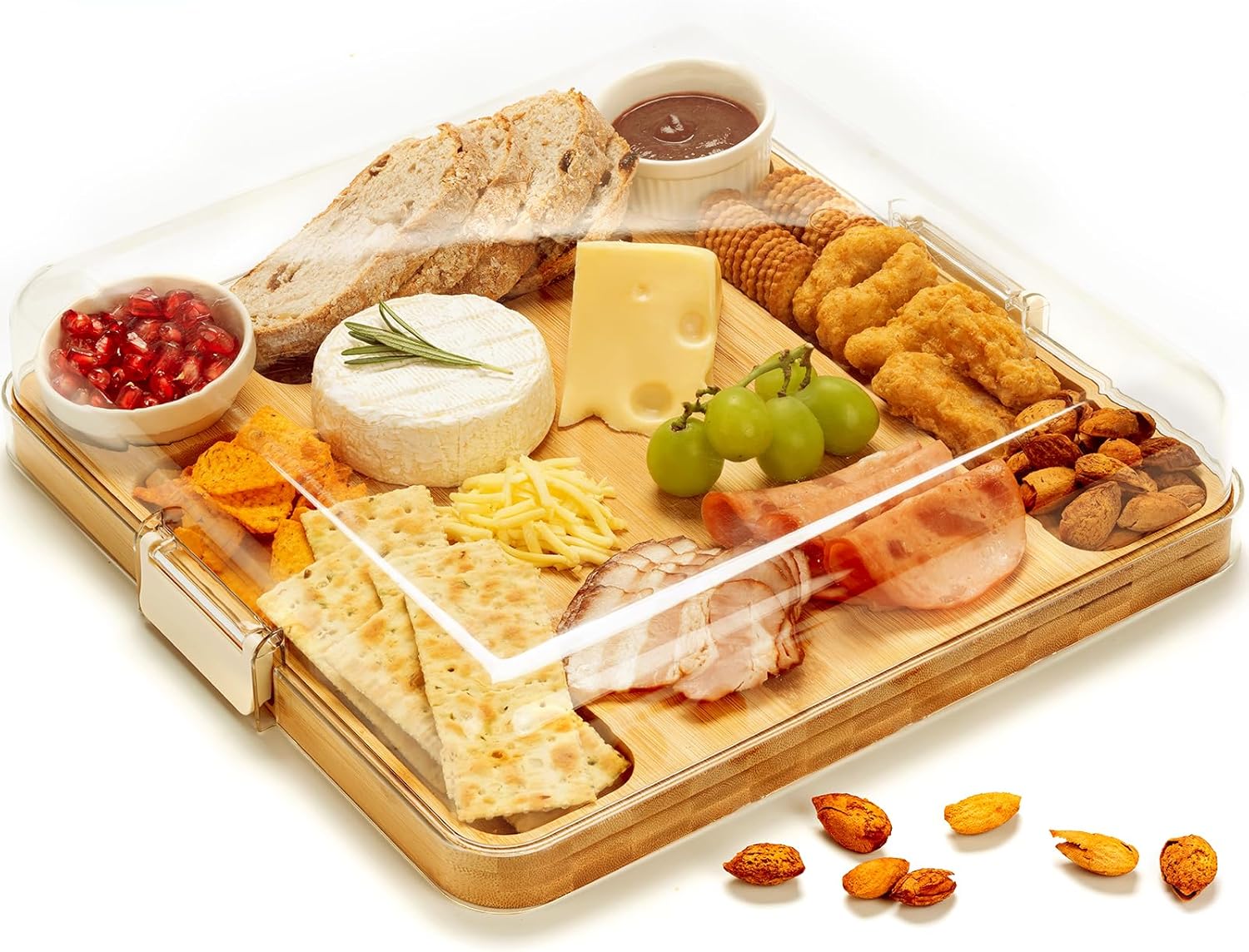 Bamboo cheese and snack board under a transparent lid, arranged with cheese, fruit, bread and small sauce bowls