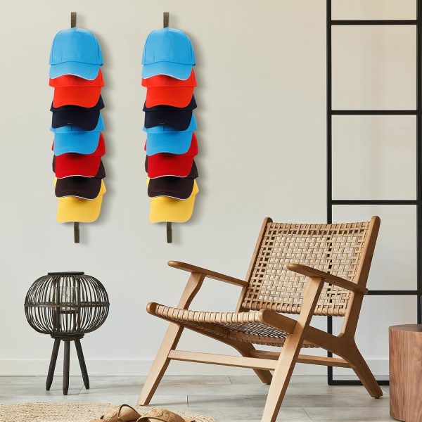 Two wall mounted wooden hat racks with colourful baseball caps beside a woven lounge chair