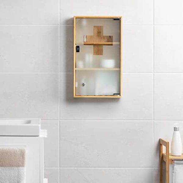 Lockable bamboo medicine cabinet with frosted glass door and cross motif mounted on a bathroom wall