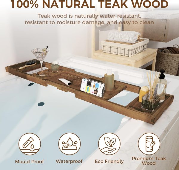 Teak bath tray extended across a white bathtub with a glass holder, phone support and accessory areas