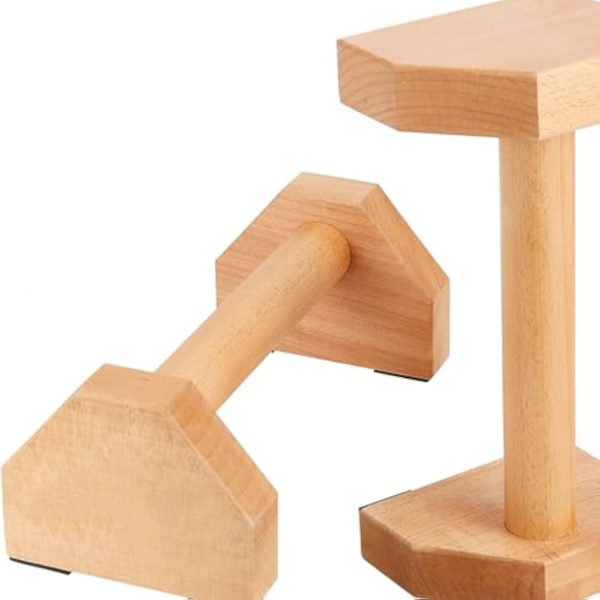 Pair of beech wood parallettes with rounded handles and shaped wooden end supports shown at different angles