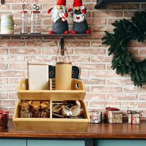 Two bamboo stackable vegetable storage bins displaying jars, cups and kitchen items on a counter