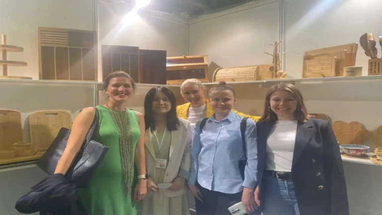 Bamboo product supplier team beside a product display